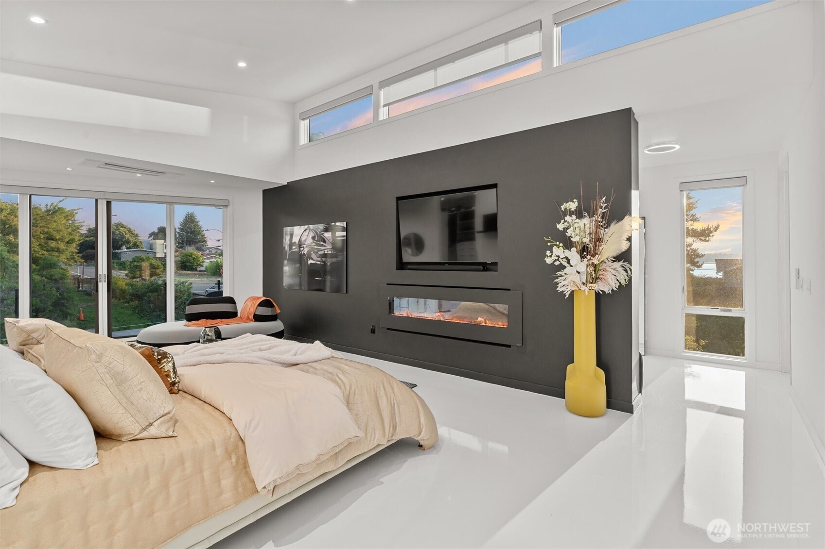 903 North 33rd Place Renton, WA 98056 - Photo 16 of 28 a bedroom with a large bed a chandelier and flat screen tv