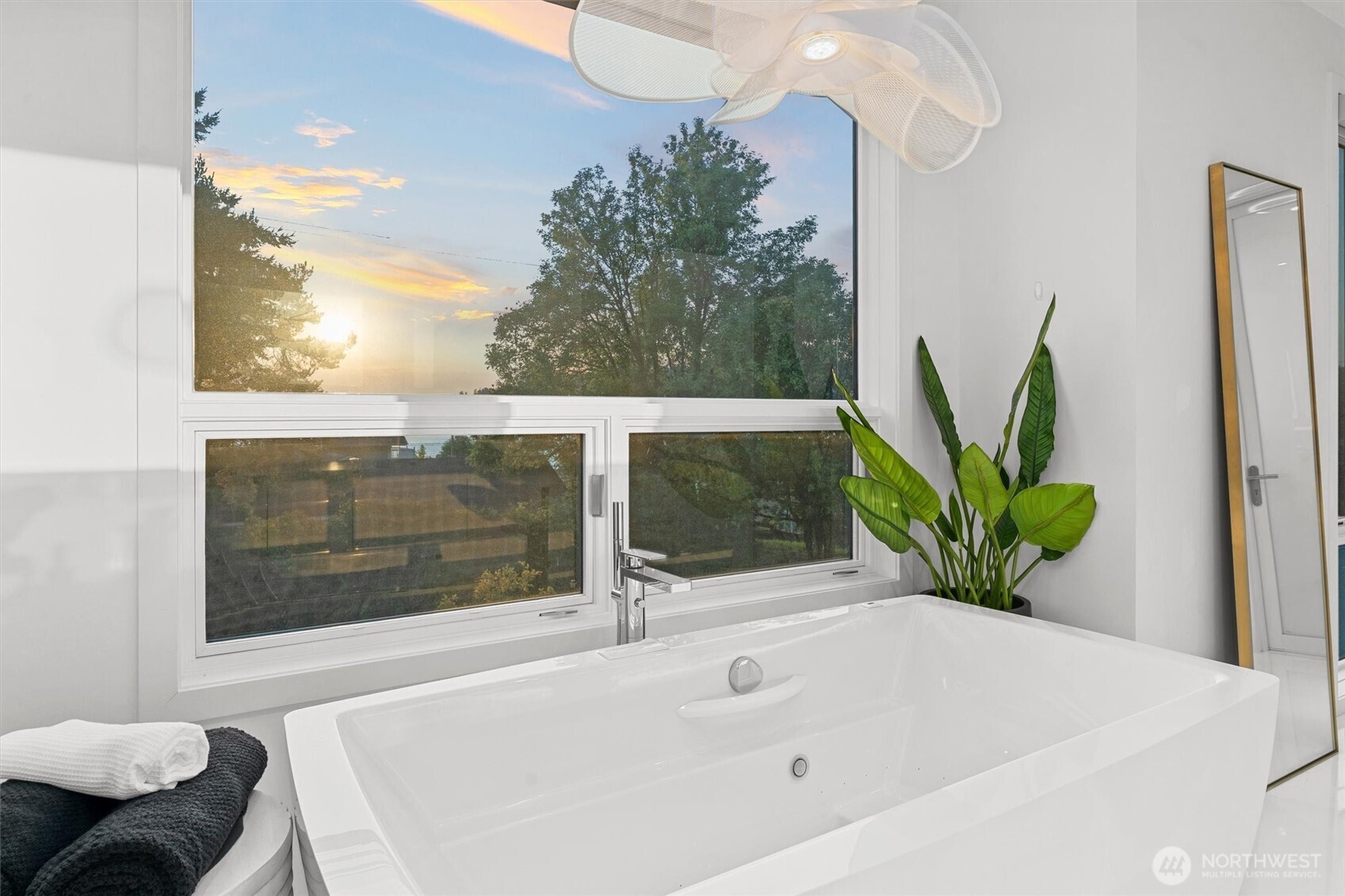 903 North 33rd Place Renton, WA 98056 - Photo 20 of 28 a white bath tub sitting in a bathroom next to a window
