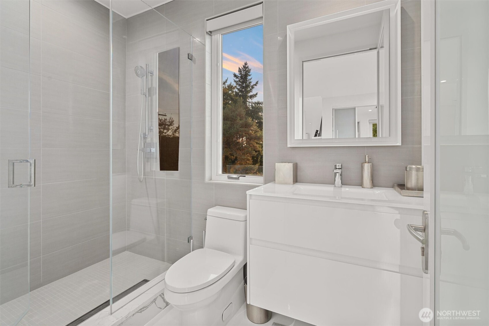 903 North 33rd Place Renton, WA 98056 - Photo 24 of 28 a bathroom with a toilet sink vanity and mirror