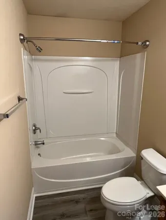 a bathroom with a toilet and a bathtub