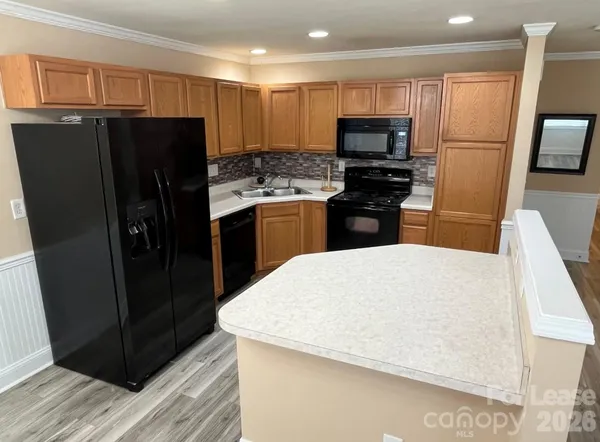a kitchen with a refrigerator a microwave and sink