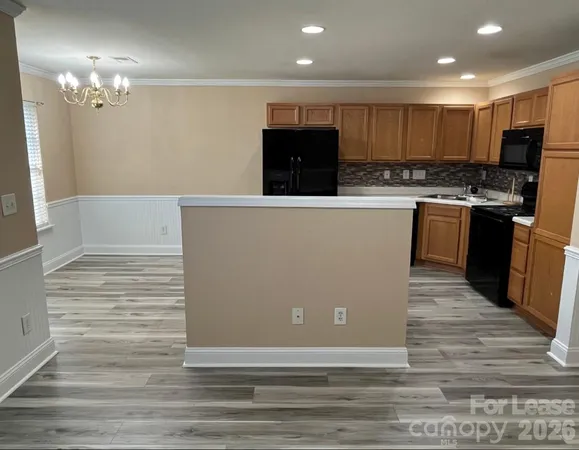 a view of kitchen with microwave and cabinets