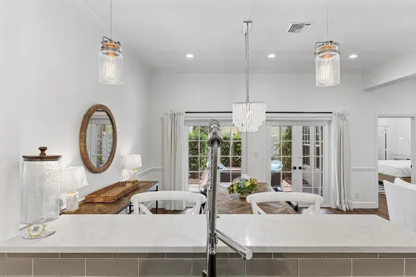 a living room with furniture a rug and a chandelier