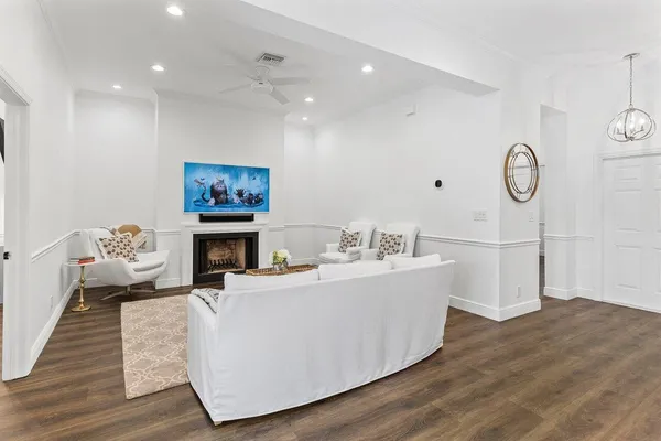 a living room with furniture and wooden floor