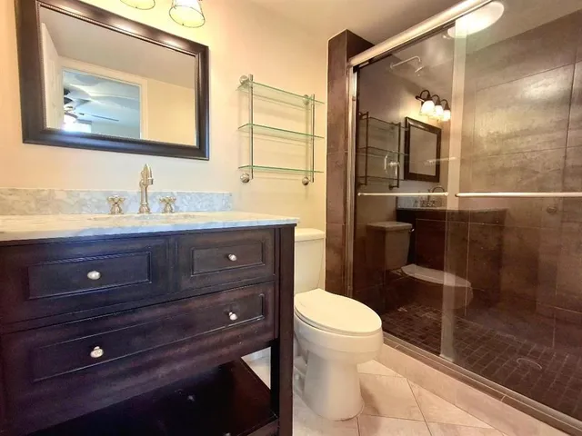 a bathroom with a toilet a sink and mirror