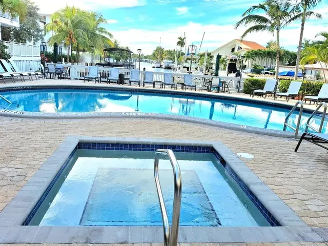 a view of swimming pool with outdoor seating and city view
