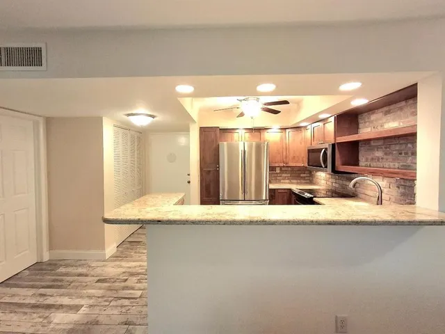 a large bathroom with a granite countertop sink a mirror and a shower