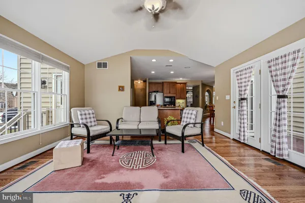 a bedroom with a bed chair and dresser