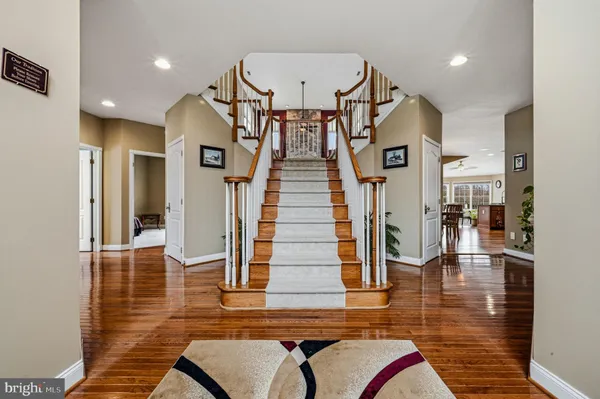 a view of a hallway with wooden floor and furniture