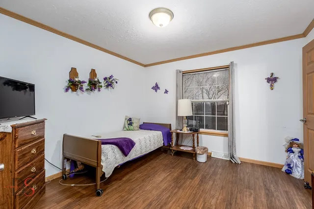 a bed room with a bed and a chair