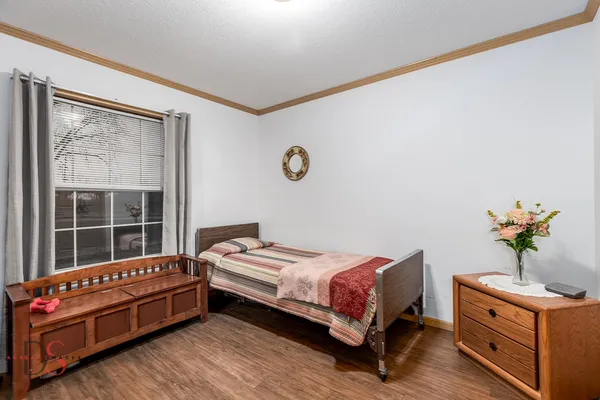 a bedroom with a bed and a window