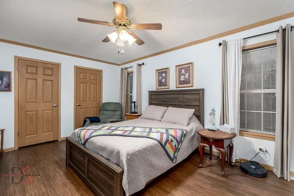a bedroom with a bed and a chandelier