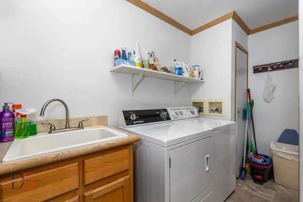 a utility room with sink dryer and washer