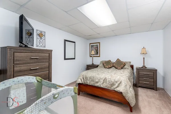 a bedroom with a bed and a television