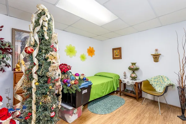 a living room with furniture and flowers