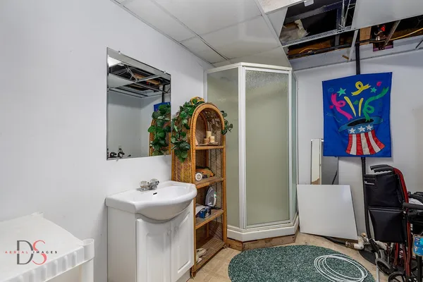 a view of bathroom with a sink and mirror
