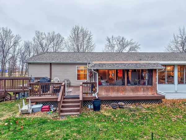 a view of a house with a yard and furniture