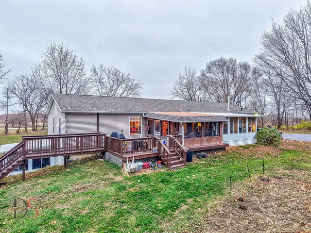 a view of a patio with furniture and a yard