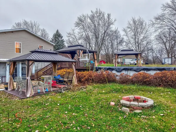 a view of an house with backyard and a slide