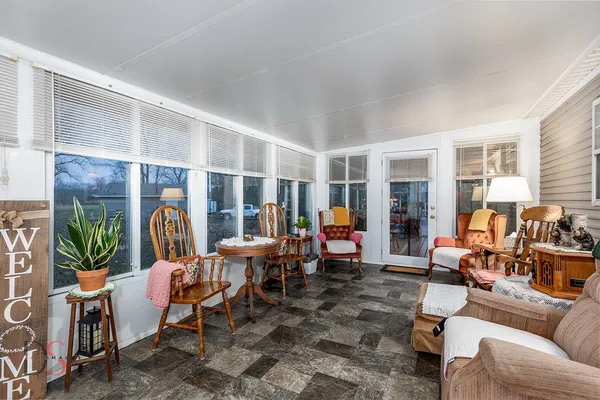 a living room with furniture fireplace and potted plants