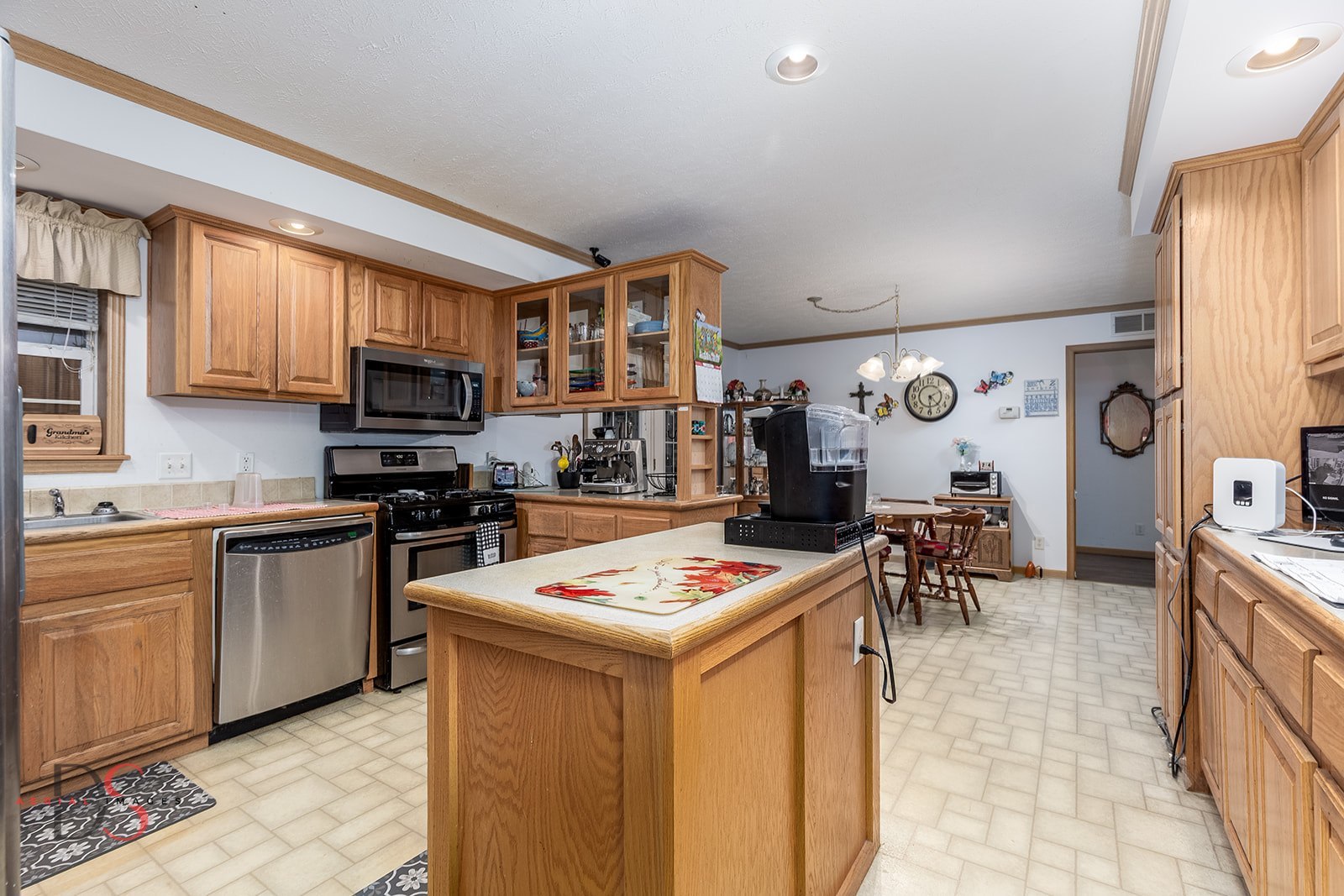 32415 North 600 E Road Streator, IL 61364 - Photo 8 of 44 a open kitchen with stainless steel appliances granite countertop a stove top oven a sink a dining table and chairs with the front door