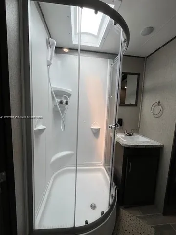 a bathroom with a sink mirror toilet and bathtub
