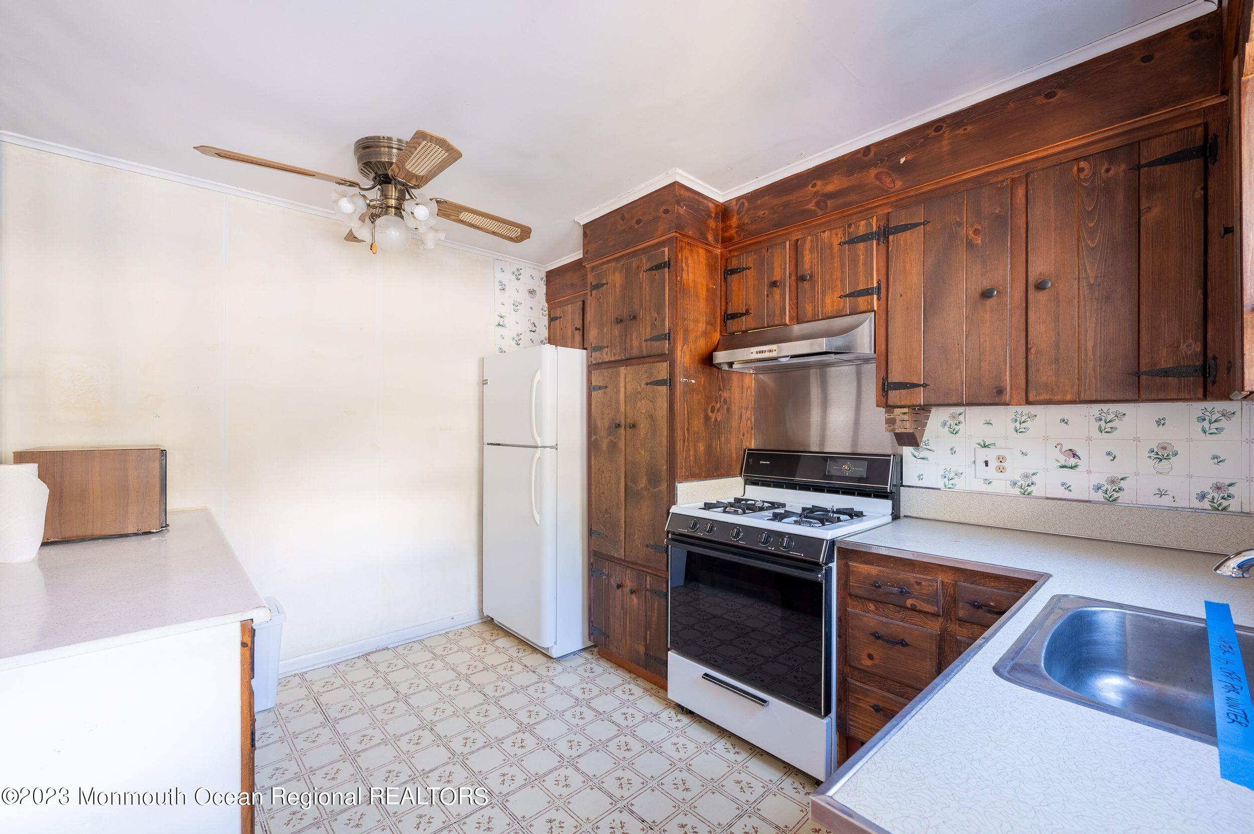 660 Pine Meadow Road Brick, NJ 08724 - Photo 13 of 67 a kitchen with stainless steel appliances granite countertop a stove and a refrigerator