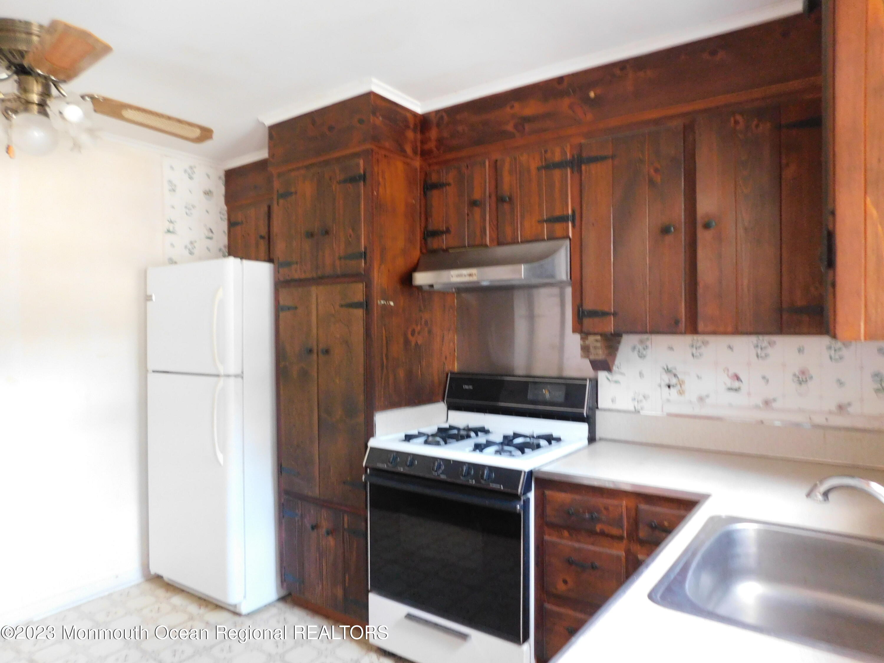 660 Pine Meadow Road Brick, NJ 08724 - Photo 14 of 67 a kitchen with stainless steel appliances granite countertop a refrigerator stove and a sink