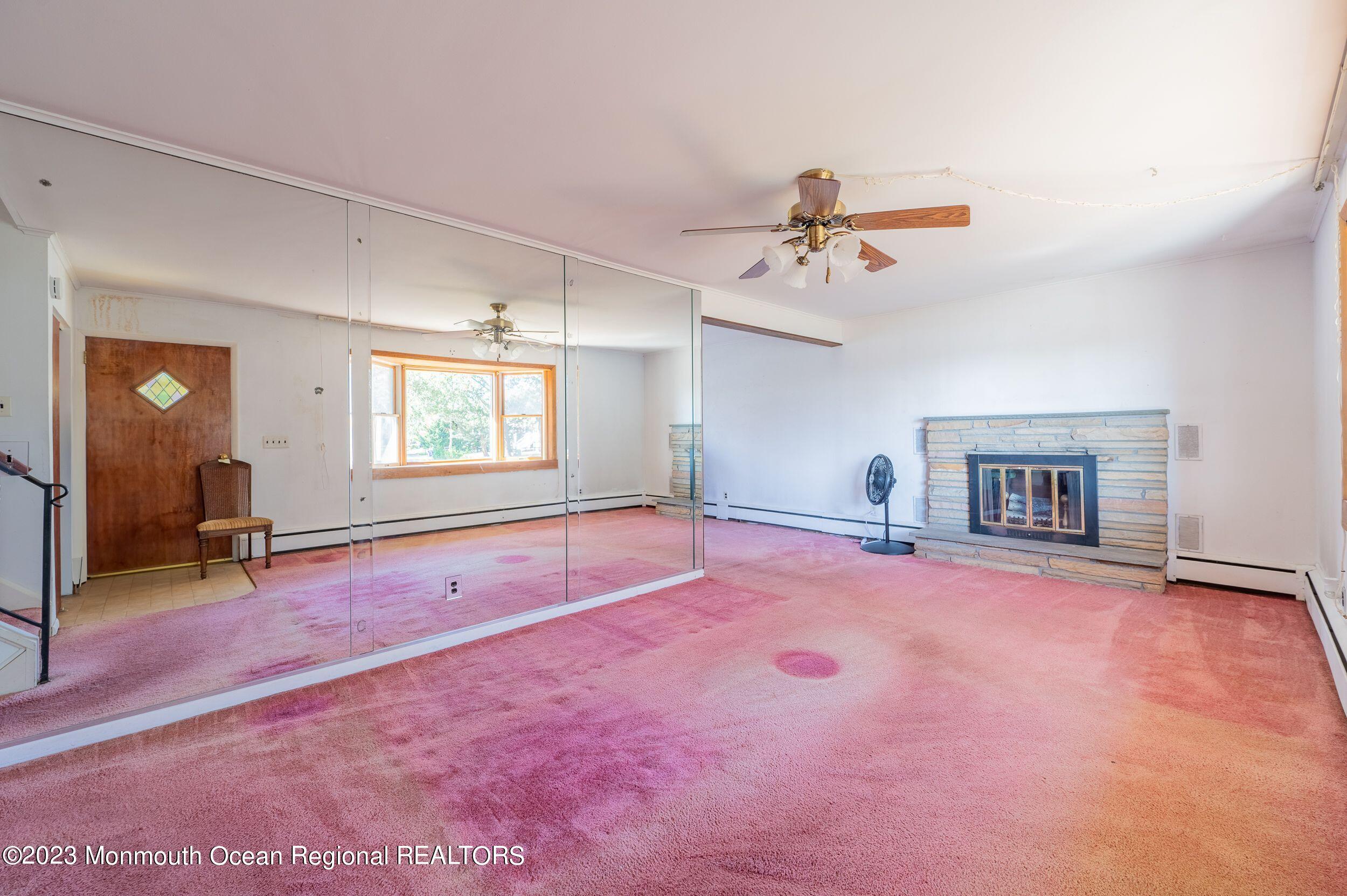 660 Pine Meadow Road Brick, NJ 08724 - Photo 20 of 67 an empty room with windows and fireplace