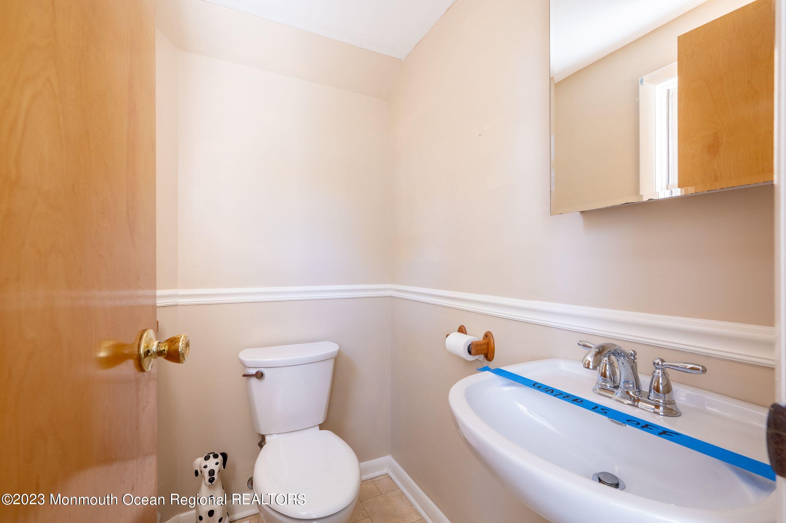 660 Pine Meadow Road Brick, NJ 08724 - Photo 26 of 67 a bathroom with a toilet sink and mirror