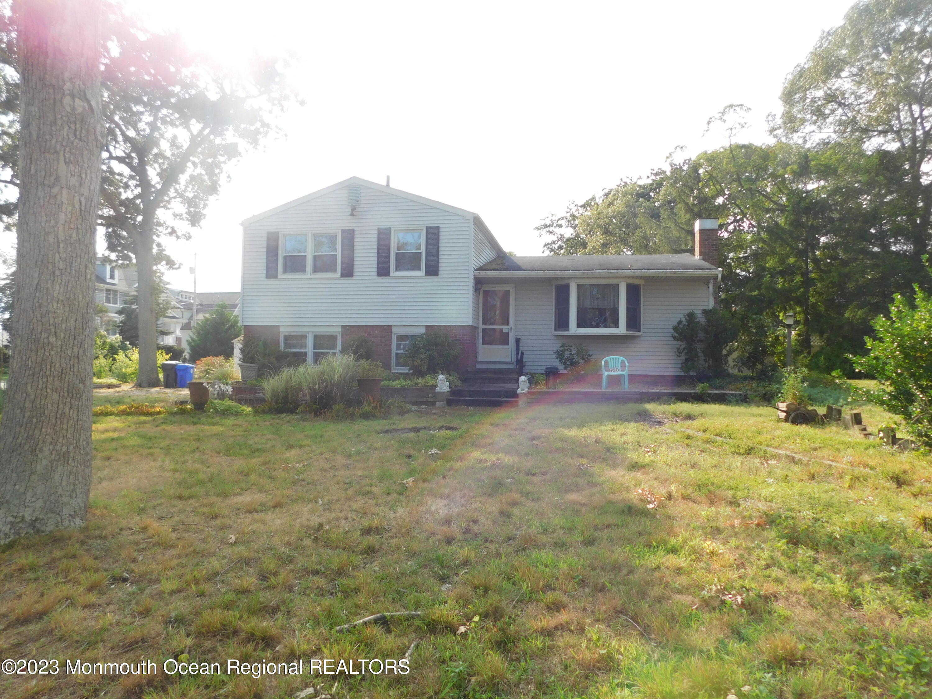 660 Pine Meadow Road Brick, NJ 08724 - Photo 38 of 67 a front view of house with yard and seating area