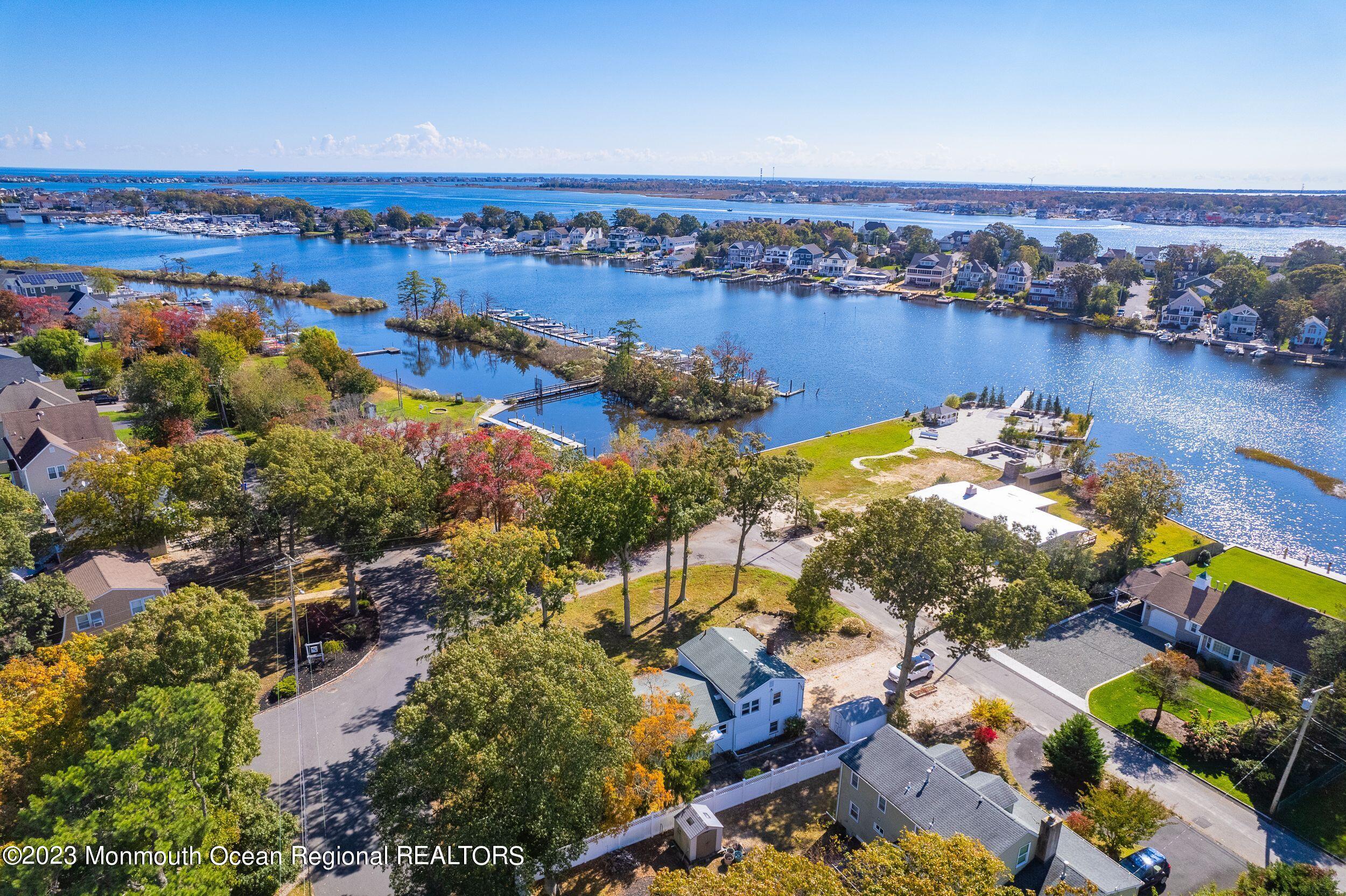 660 Pine Meadow Road Brick, NJ 08724 - Photo 42 of 67 an aerial view of lake and residential houses with outdoor space