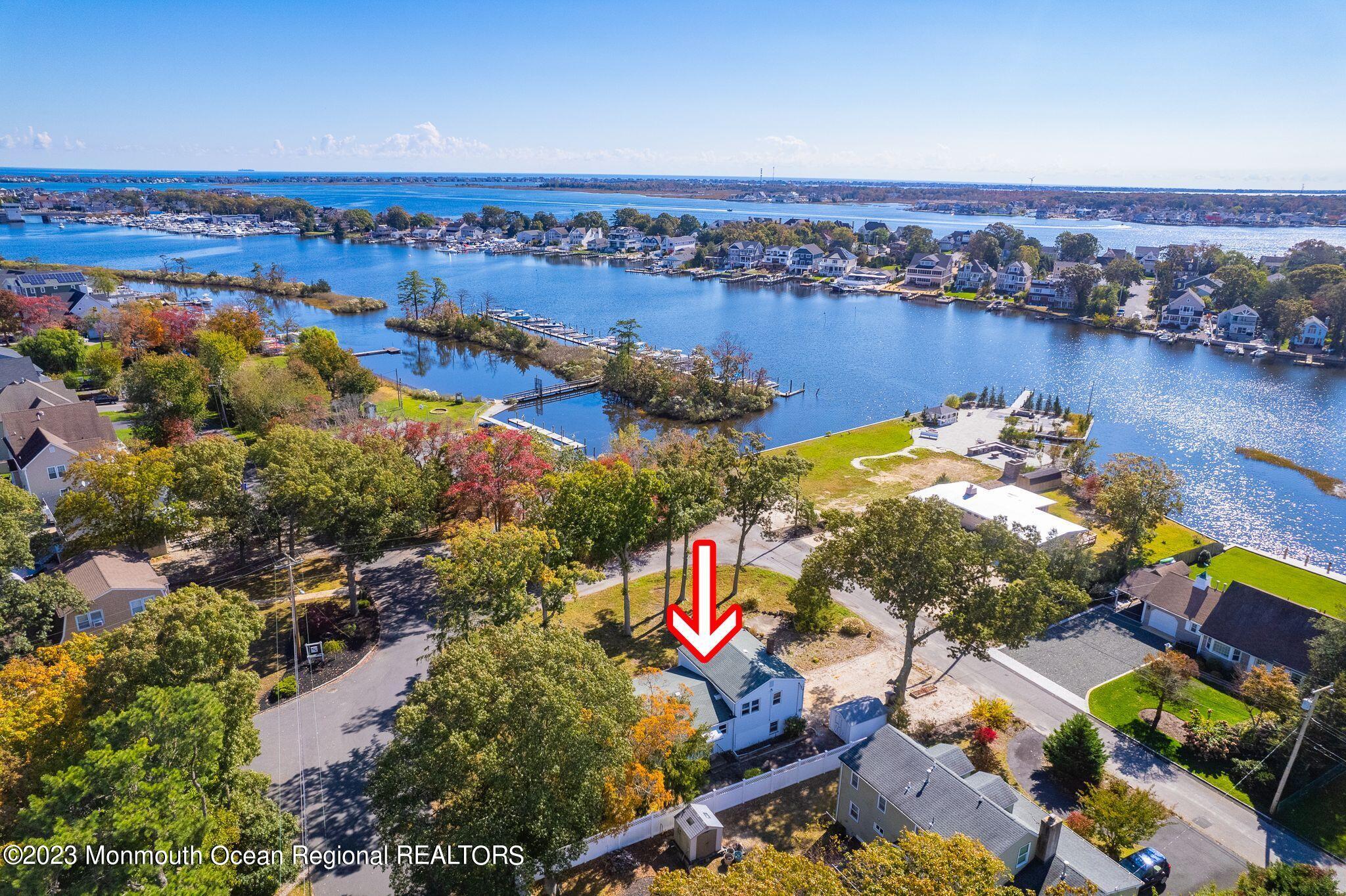 660 Pine Meadow Road Brick, NJ 08724 - Photo 63 of 67 an aerial view of lake and residential houses with outdoor space