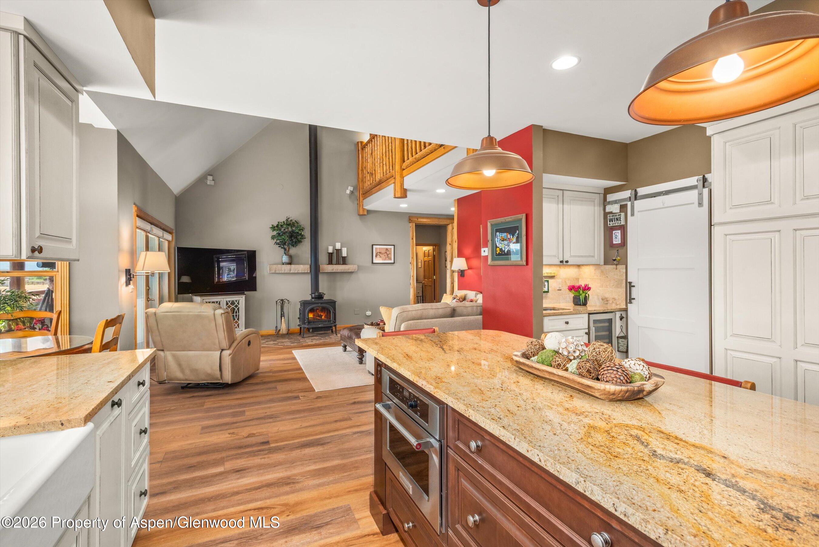 614 Escalante Road Carbondale, CO 81623 - Photo 12 of 46 a kitchen that has a lot of cabinets a sink and a wooden floor in it