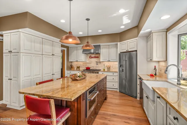 a kitchen with a sink refrigerator and microwave
