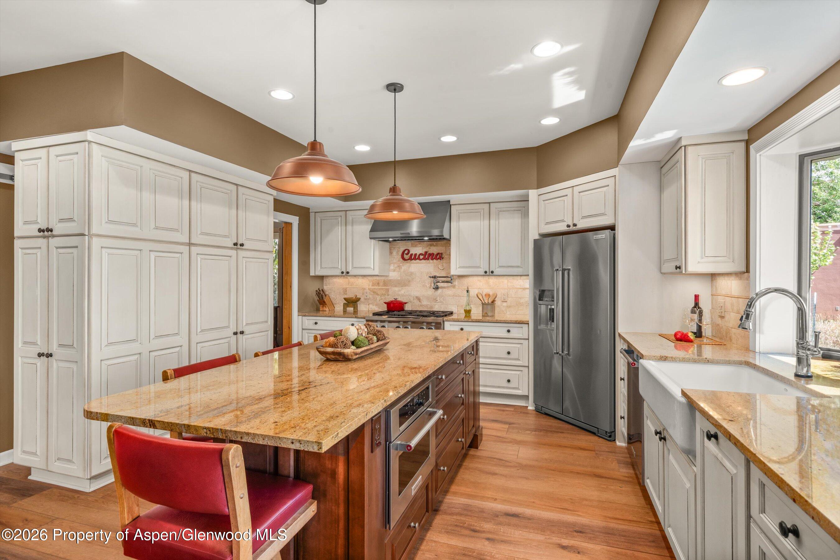 614 Escalante Road Carbondale, CO 81623 - Photo 13 of 46 a kitchen with a sink refrigerator and microwave
