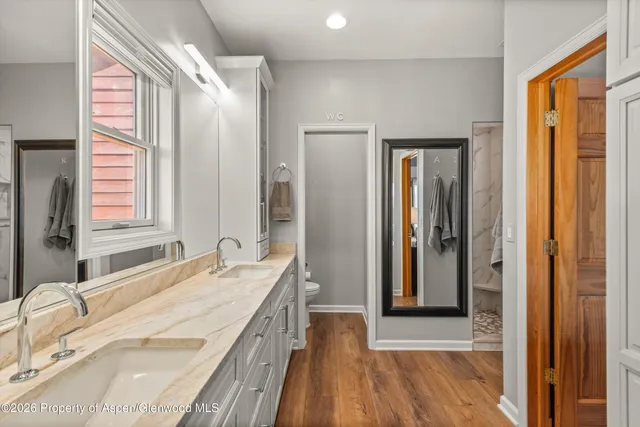a bathroom with a shower and a glass door