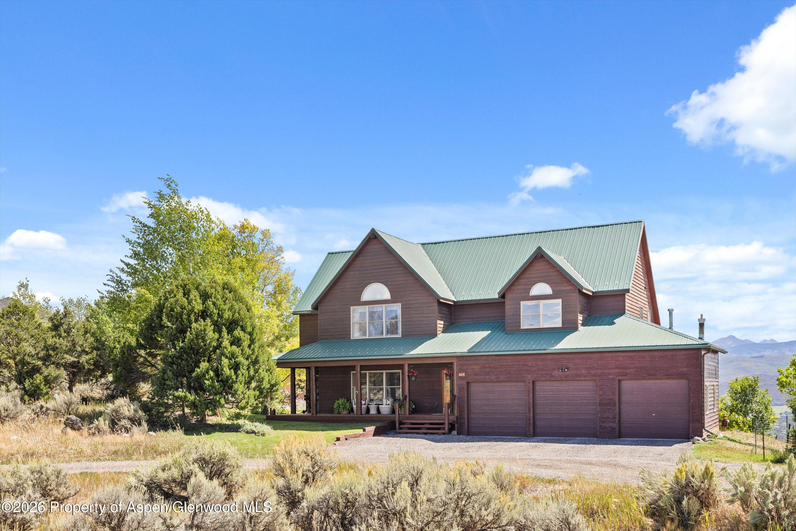 614 Escalante Road Carbondale, CO 81623 - Photo 3 of 46 a front view of a house with a yard