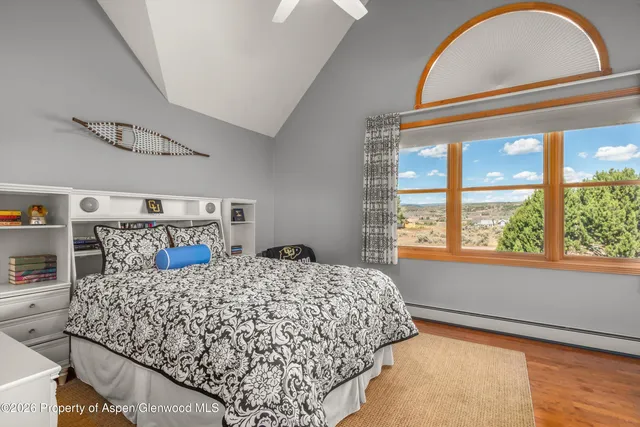 a spacious bedroom with a bed and a couch