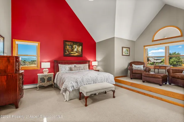 a bedroom with a bed and a dresser in it