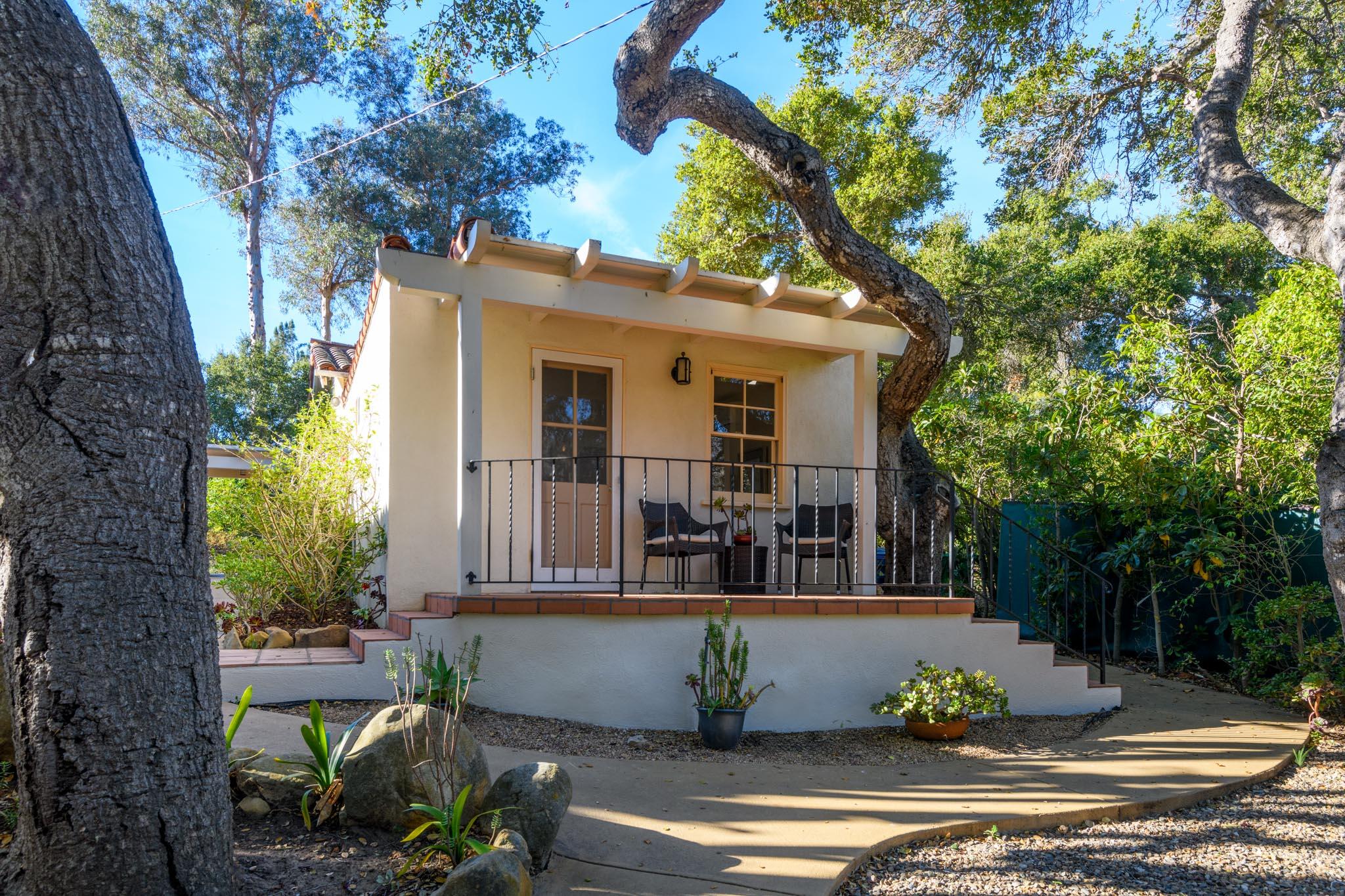937 Arcady Road Santa Barbara, CA 93108 - Photo 22 of 31 a view of a house with potted plants and a large tree