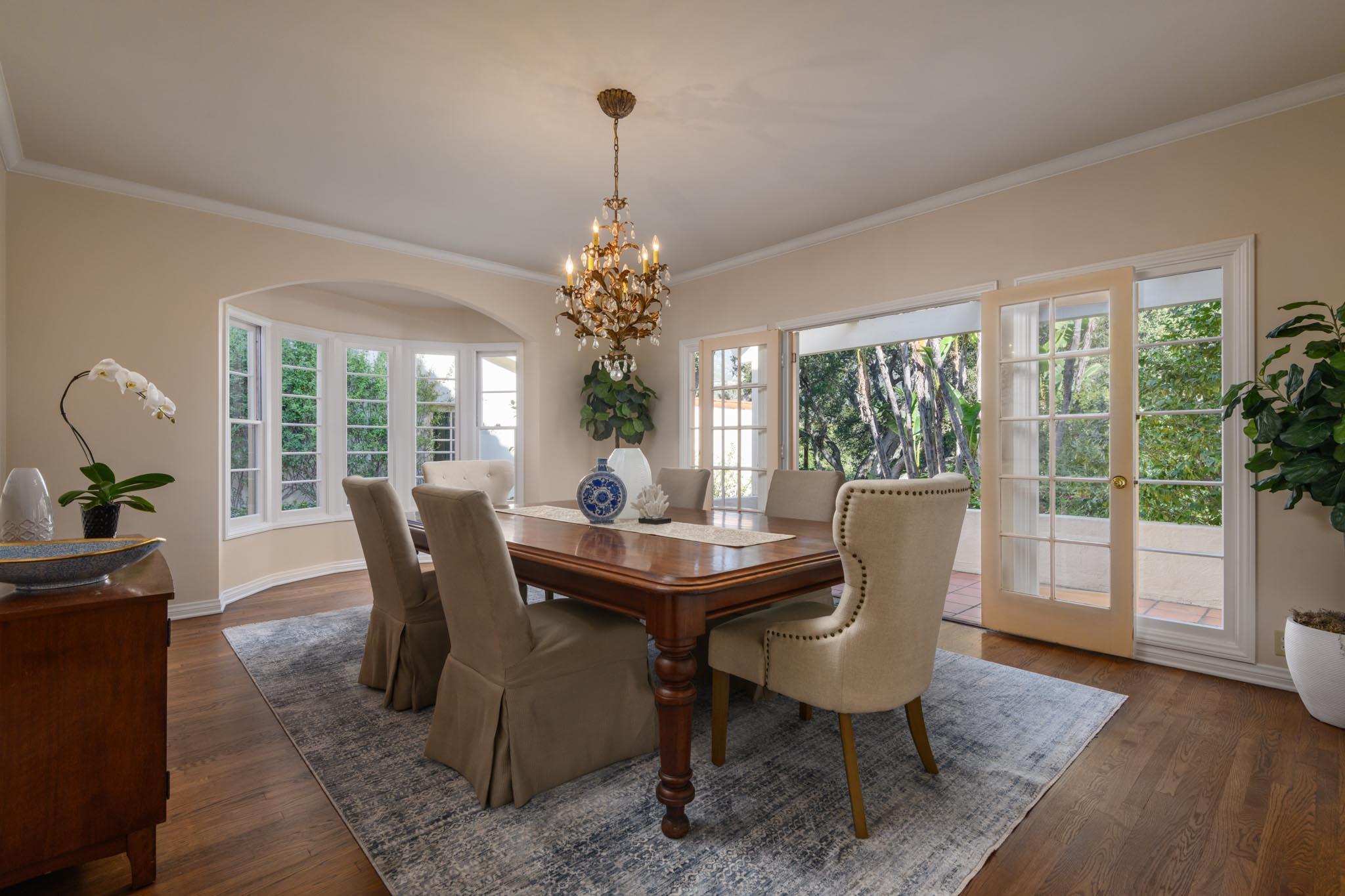 937 Arcady Road Santa Barbara, CA 93108 - Photo 9 of 31 a dining room with furniture wooden floor a potted plant and a chandelier
