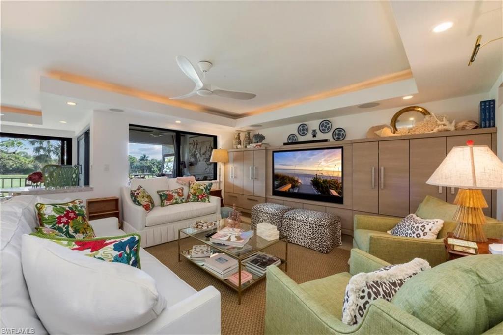 107 Clubhouse Lane, Unit 391 Naples, FL 34105 - Photo 1 of 37 a living room with furniture and a flat screen tv