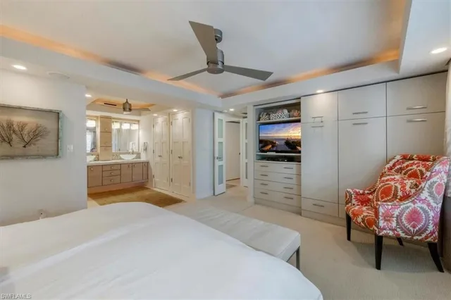 a bedroom with furniture and a flat screen tv