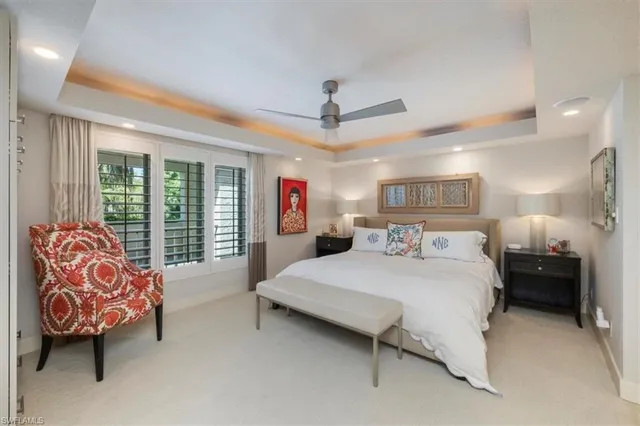 a bedroom with a large bed and a chandelier