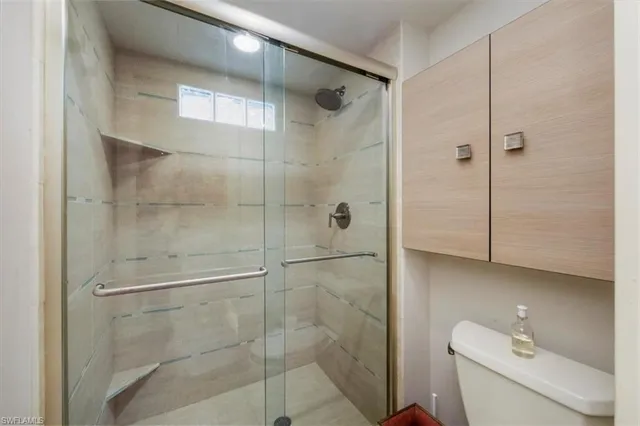 a bathroom with a shower and toilet
