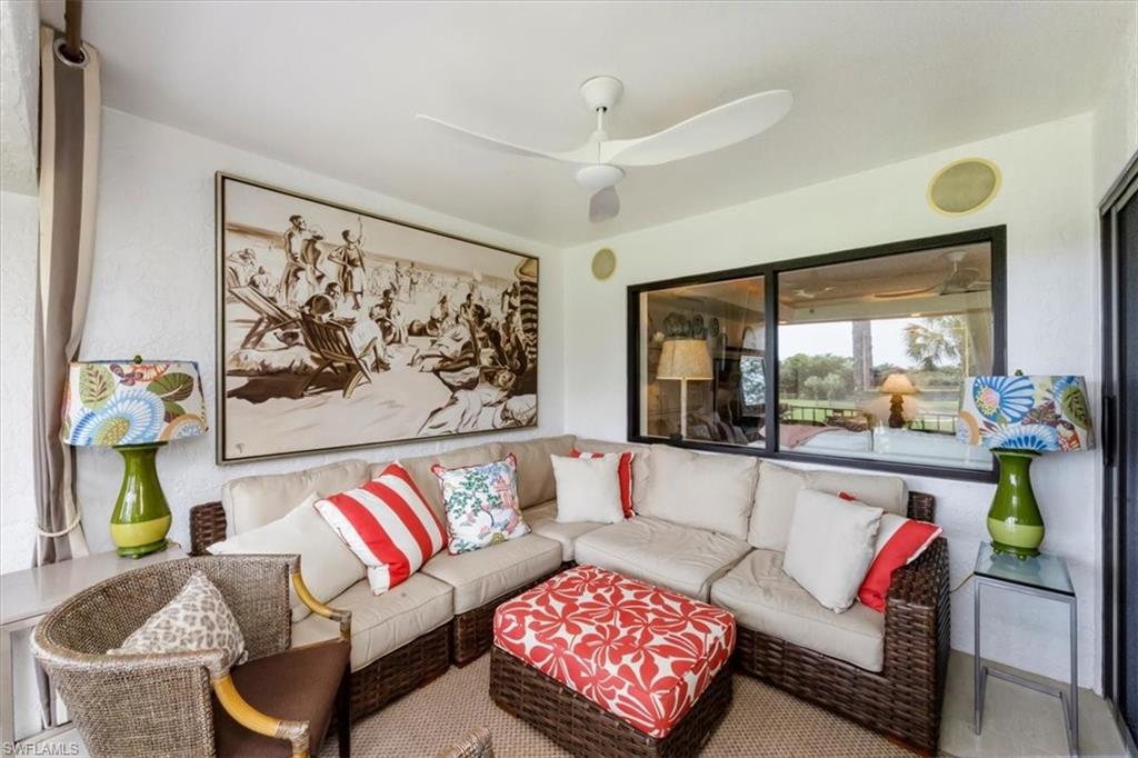 107 Clubhouse Lane, Unit 391 Naples, FL 34105 - Photo 23 of 37 a living room with furniture and a large window