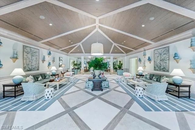 a living room with lots of furniture and a large window