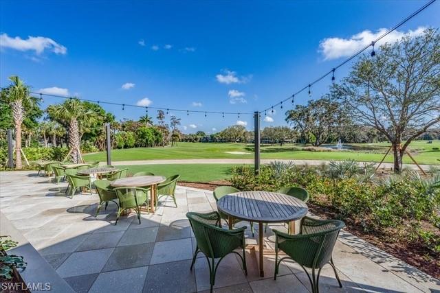 107 Clubhouse Lane, Unit 391 Naples, FL 34105 - Photo 33 of 37 a view of a table and chairs in patio with a yard