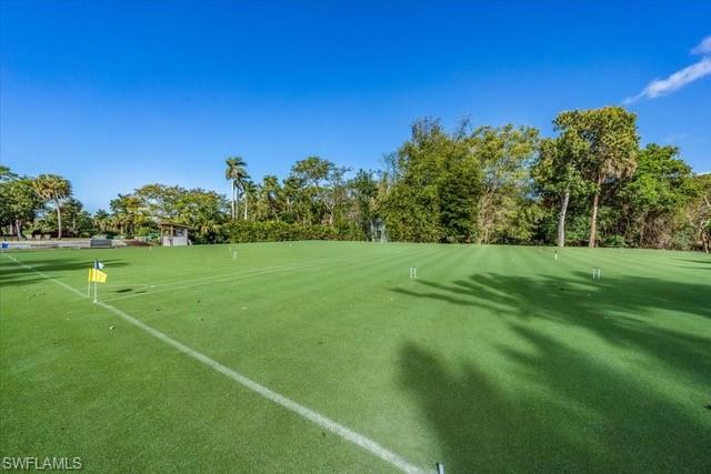 107 Clubhouse Lane, Unit 391 Naples, FL 34105 - Photo 37 of 37 a view of a grassy field with trees in the background